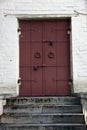 Old stone steps leading to a metallic door Royalty Free Stock Photo