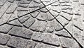 Old stone tiled floor with round pattern on a sunny street, review Royalty Free Stock Photo