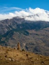 Old stone tomb, a crypt on the top of a mountain. Tombstones made of stone. Ossetia region. Vertical view Royalty Free Stock Photo