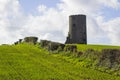 An old stone tower in a cut hay field on a farm in County Down in Ireland Royalty Free Stock Photo