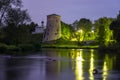 Old stone tower of medieval fortress and small church reflecting in river at night. Pskov fortifications, Russia Royalty Free Stock Photo