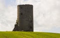 An old stone tower of unknown origin to the photographer in a cut hay field on a farm near Kircubbin in Northern Ireland Royalty Free Stock Photo
