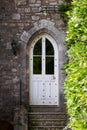 Old stone townhouse or castle arched door with stairs