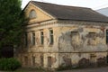 Old stone tumbledown house in russian provincial town at sunset