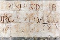 Old stone wall with ancient lettering in Florence, Italy