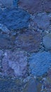An old stone wall. Background of blue stones. The texture of the stone. Masonry. Vertical image. Royalty Free Stock Photo