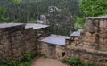 Old stone wall close-up overlooking the forest, the ruins of an old castle Royalty Free Stock Photo