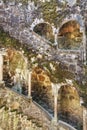 Old stone wall with columns and moss