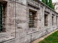 Old stone wall with lattice windows in the Suleymaniye Mosque in Istanbul Turkey