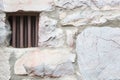 Old Stone Wall With Small Iron Barred Prison Cell Window