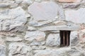 Old Stone Wall With Small Iron Barred Prison Cell Window Royalty Free Stock Photo