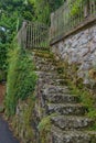 An old stone wall with a staircase among the narrow ancient streets on the mountainside.