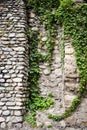 Old stone walls fortress with green ivy.Real texture of old stone bricks. Quality photo background of brickwork. Good for 3D works Royalty Free Stock Photo