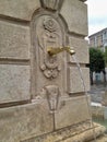 Old stone water fountain on the street in Spain Royalty Free Stock Photo