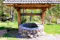 Old stone well of a rustic garden Royalty Free Stock Photo