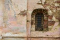 Old stone window old Russian style. Vintage window of a 16th-century Church with peeling bricks in Russia. Bars on an ancient Royalty Free Stock Photo