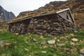 Old stone and wood house covered with moss on the background of the mountains. Place for text or advertising Royalty Free Stock Photo