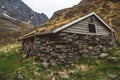 Old stone and wood house covered with moss on the background of the mountains. Place for text or advertising Royalty Free Stock Photo