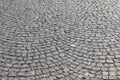 An old stoneblock pavement cobbled in an arc pattern. Photo in perspective Royalty Free Stock Photo