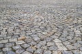 An old stoneblock pavement cobbled in an arc pattern. Photo in perspective view with selective focus Royalty Free Stock Photo