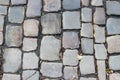 An old stoneblock pavement cobbled with natural stone blocks with gaps between blocks Royalty Free Stock Photo