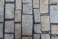 An old stoneblock pavement cobbled with rectangular granite blocks with crushed rock fines between blocks Royalty Free Stock Photo