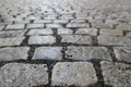 An old stoneblock pavement cobbled with rectangular granite blocks with crushed rock fines between blocks as a background Royalty Free Stock Photo