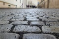 An old stoneblock pavement cobbled with rectangular granite blocks with crushed rock fines between blocks as a background Royalty Free Stock Photo