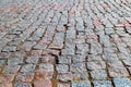 An old stoneblock pavement cobbled with rectangular granite blocks. Photo in perspective with selective focus Royalty Free Stock Photo