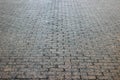 An old stoneblock pavement cobbled with rectangular granite blocks in perspective. Background photo with selective focus Royalty Free Stock Photo