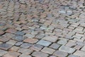 An old stoneblock pavement cobbled with rectangular natural stone blocks with one green leaf on it in the center Royalty Free Stock Photo