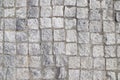 An old stoneblock pavement cobbled with square granite blocks as a background Royalty Free Stock Photo