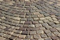 An old stoneblock pavement cobbled with square stone blocks. Photo in perspective