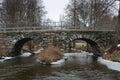 Old stonebridge over the cold water Royalty Free Stock Photo