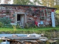 Old stony basement build in hill. Rusty old bycicle, rotting shops and junk Royalty Free Stock Photo