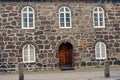 Old stony building with windows. Wall made out of big stones. Old building material concept. Ancient stony house or part Royalty Free Stock Photo