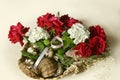 Straw basket with a bouquet of red roses, white hydrangeas and eucalyptus branches with sea shells Royalty Free Stock Photo