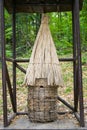 An old straw beehive in the woods Royalty Free Stock Photo