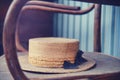 Old straw hat on vintage shabby chair, close-up Royalty Free Stock Photo