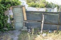 old street door and mesh wall and degraded materials for access security to the housing tent