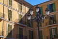 Old street lamp in front of facade of mediterranean house, light shines over half of the house Royalty Free Stock Photo