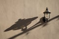 Old street lamp with long shadow on the wall Royalty Free Stock Photo