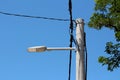 Old street lamp plastic casing upgraded with modern LED lights on strong concrete electrical utility pole with thick black Royalty Free Stock Photo