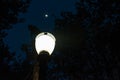 Old street lamp, symbol of the city of Sao Paulo, Brazil,with the moon at the back