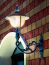 Old street lamp on the wall, glowing. Tunisia, Africa Royalty Free Stock Photo