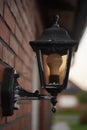 Old street lamp on the wall with a modern lamp Royalty Free Stock Photo