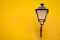 Old street lamp on a yellow wall Royalty Free Stock Photo