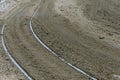 Old street lined with paving stones strewn with snow with tramways Royalty Free Stock Photo