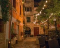 Old street in Porec town illuminated by lamps at the evening