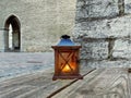 Old street  wooden lantern yellow light on wooden bench near  medieval wall in  old town of Tallinn Royalty Free Stock Photo